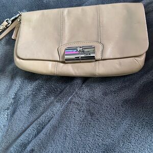 Coach Tan Leather Wallet with Pebbled Texture and Flap Closure